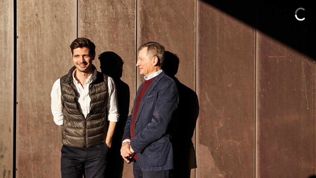 Nicholas Meilstrup, CEO of Danish fintech Crediwire, smiling in sunlight alongside an unidentified man.