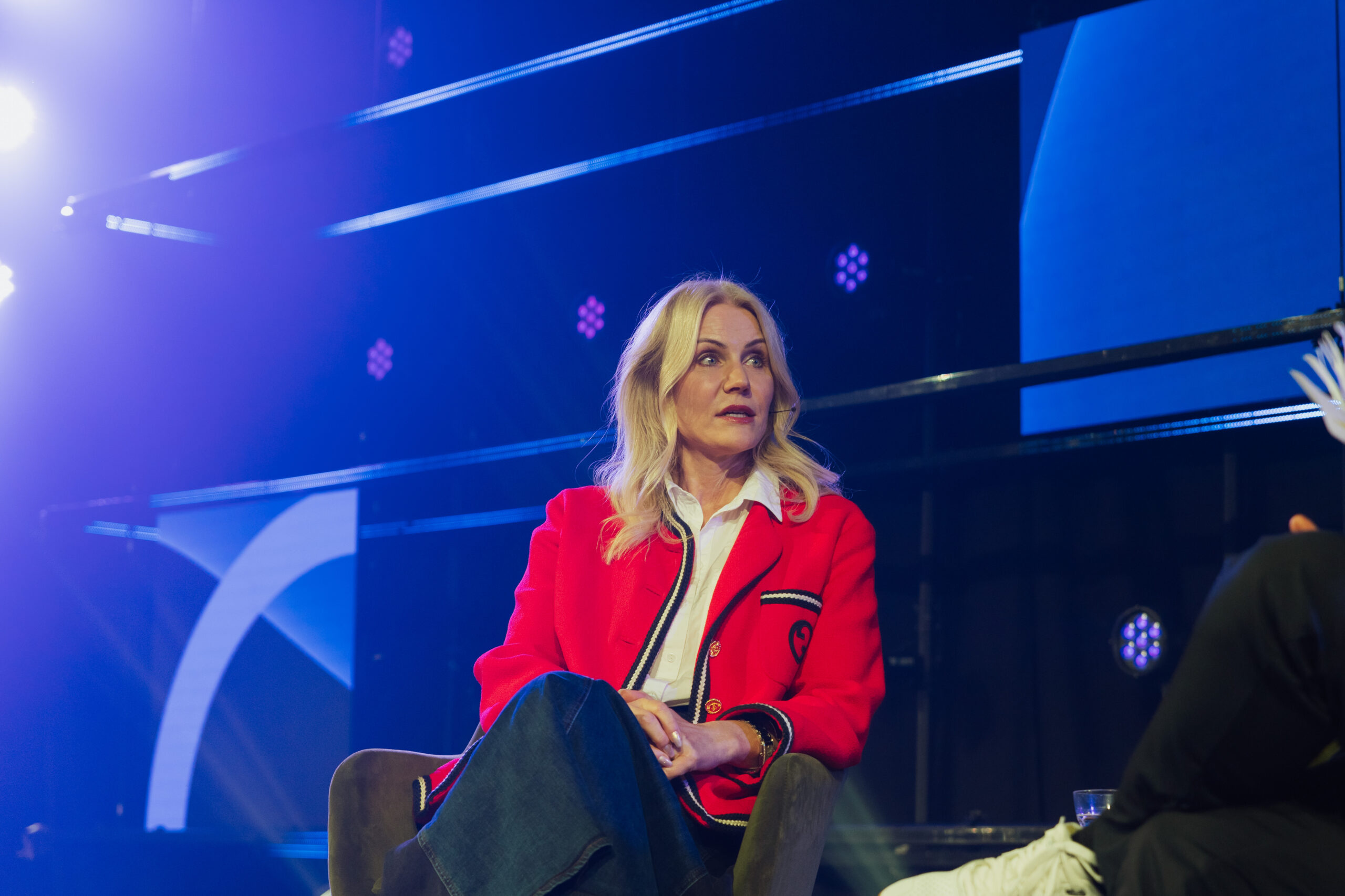 Woman speaker dressed in red at the Tech arena 2024
