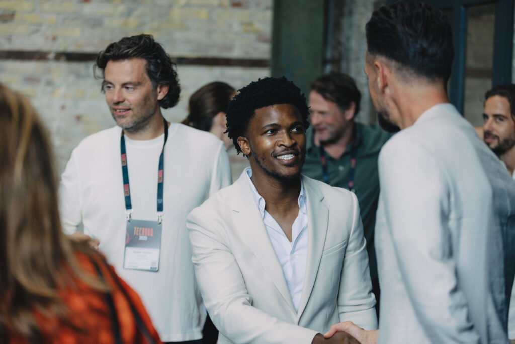Two men in white shirts shaking hands at TechBBQ